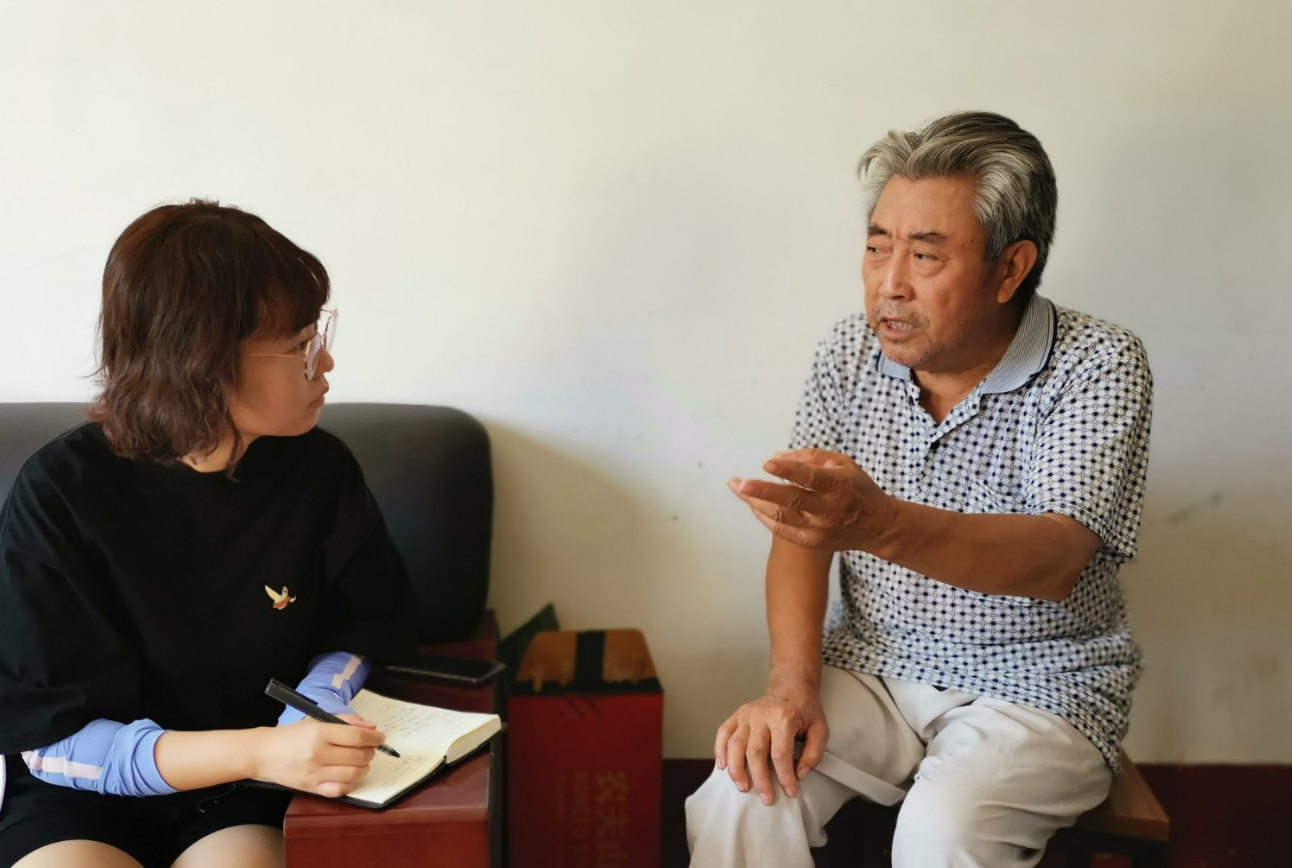 记者于新悦（左）在菏泽市曹县刘岗村采访刘全义老人。