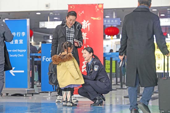 1月17日，青岛机场出入境边防检查站民警为旅客提供通关指引。