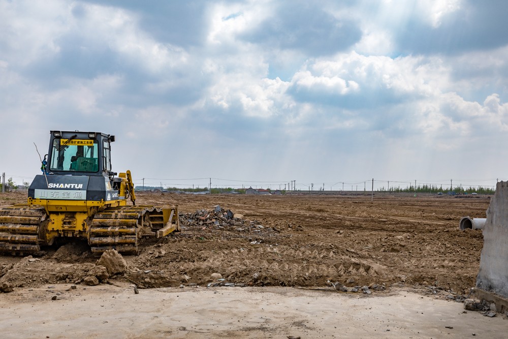 4月17日，盐窝镇七一村拆迁后大型机械正在整平土地。