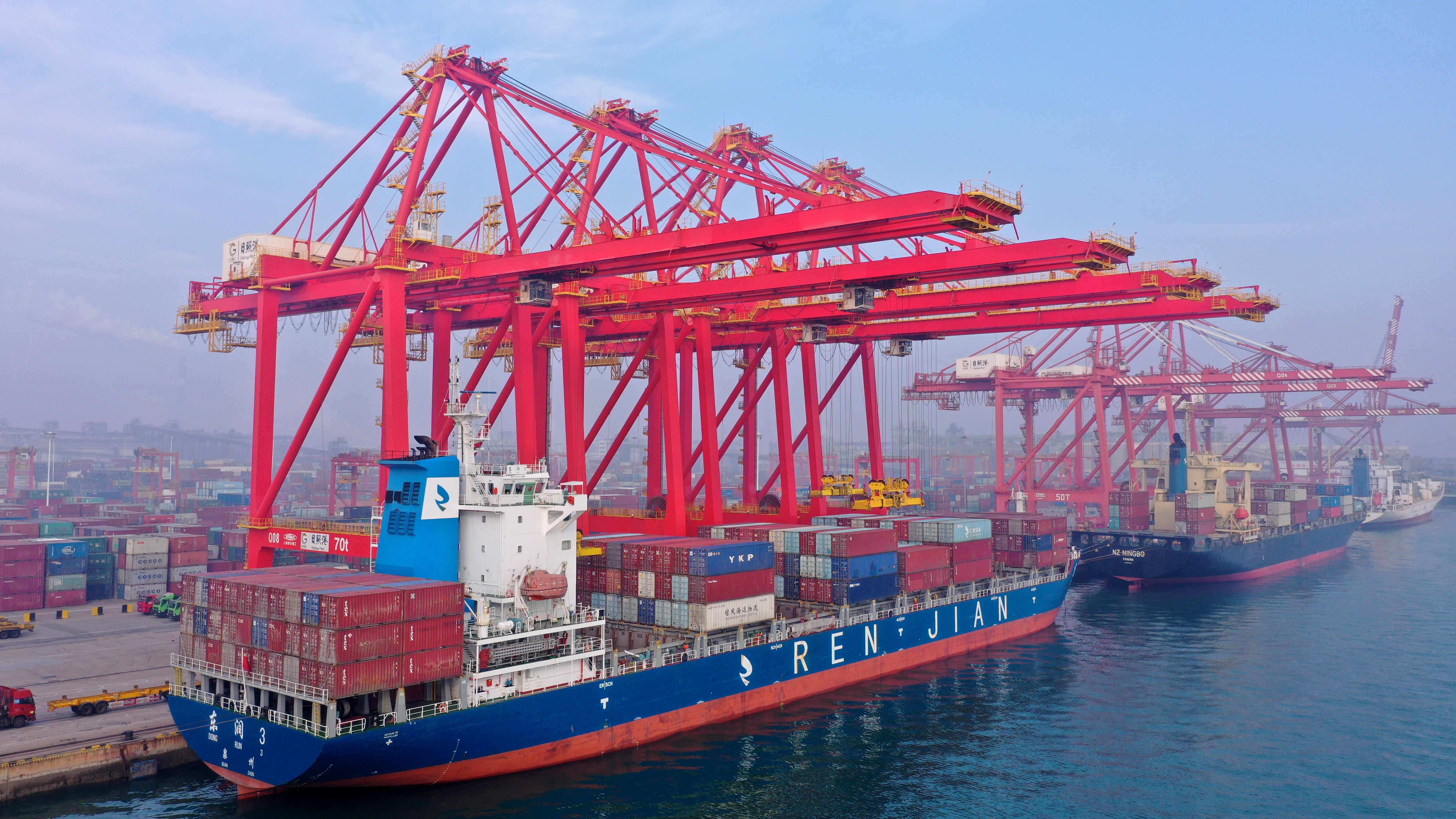 货轮停靠在日照港集装箱码头进行装卸作业。
