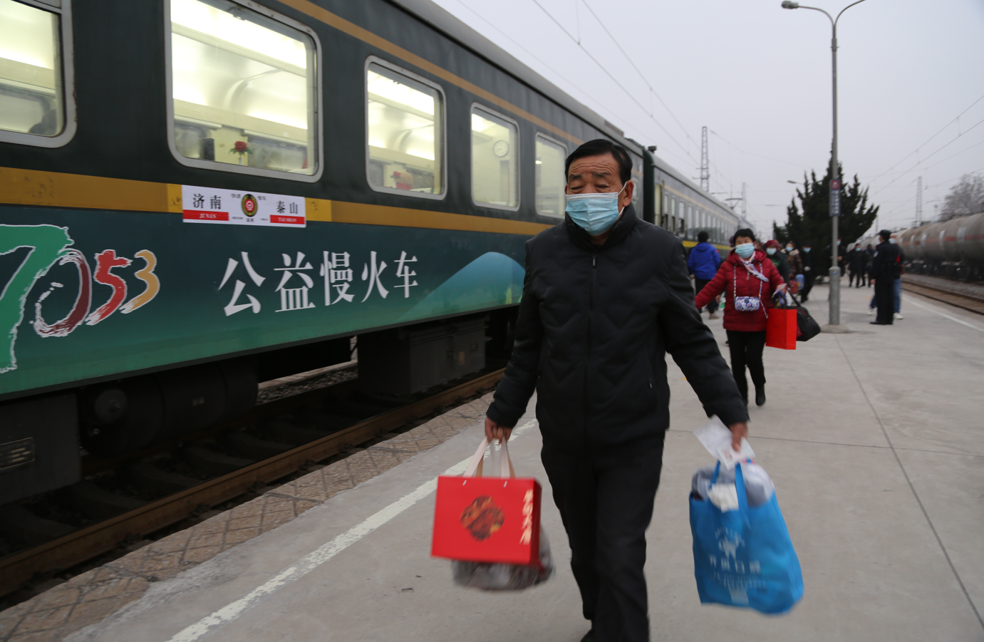 返乡乘客拎着大包小包走下7053次列车